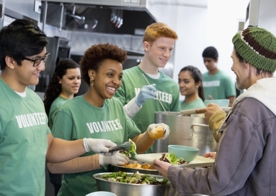 Group of volunteers serving food to people