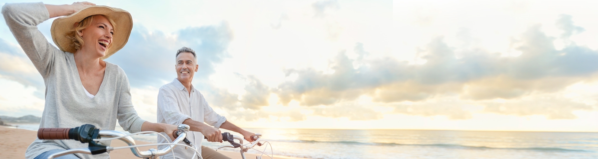 Couple riding bikes on beach